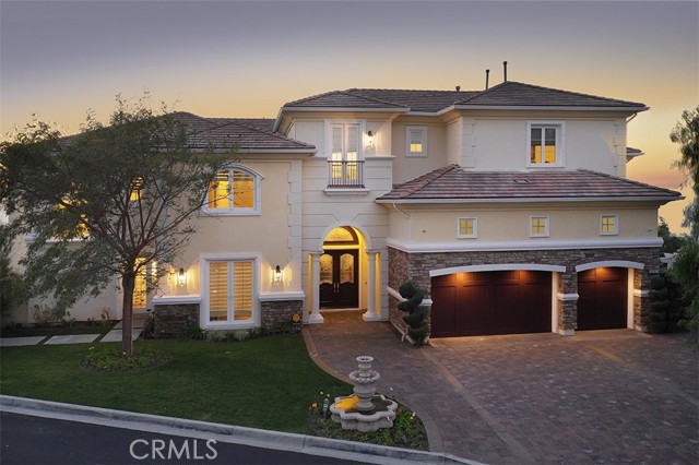 This gorgeous, custom-designed Mediterranean Estate is located at the highest point in Anaheim Hills and has the best 270 degrees of panoramic views of the city.  From Catalina Island, Los Angeles, to Anaheim, this view is nothing short of amazing. Nestled up in the mountains, surrounded by rolling hills and with few neighbors, the top-of-the-world view of the city lights and stars is breathtaking and unparalleled.   Pointe Premier is an exclusive, gated community with 12 luxury homes. This 7,463 square foot home has a 3-car garage - with room for an auto-stacker, feature 7 gorgeous bedrooms and 5 1/2 bathrooms.  The highly sought after floor plan has custom upgrades throughout, including, but not limited to: granite slab counters, designer marble and wood floors, crown moldings throughout, an enormous kitchen with walk-in pantry, vaulted ceilings, movie theater, elevator, brand name appliances throughout, surround sound, and much more.  The large side-yard boasts a custom-built heated pool along with a jacuzzi from which one can take in the one-of-a-kind view that Pointe Premier provides. This home is a must-see for anyone that wants to go home to one of the most out-of-this-world views Southern California has to offer.
