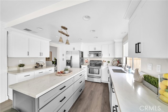 Remodeled Kitchen Features Quartz Countertops, Center Island, Custom White Shaker Soft-Closing Cabinetry, Deep Pots & Pans Drawers, Pantry with Pull-Outs, Pendent Lights Above Center Island, Recessed Lighting, Stainless Appliances, Farm Sink