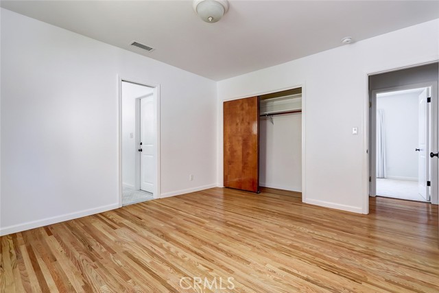 Primary suite with hardwood floors and a lovely remodeled and spacious bath.