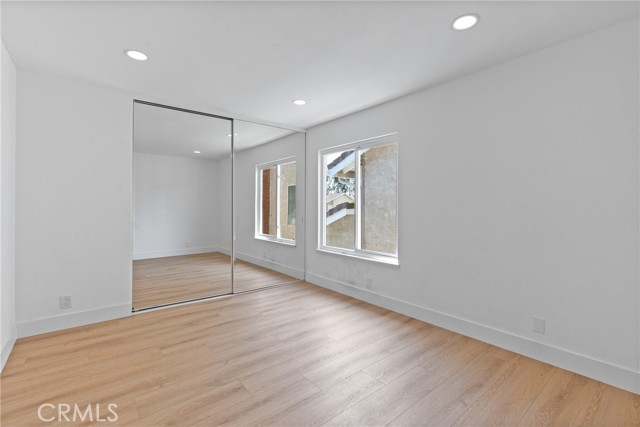 Third Bedroom, with recessed lightings, new flooring, dual pane windows and mirrored closet.