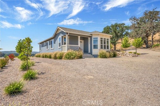 Enjoy the seclusion of a quiet country setting at this quintessential Lower Lake Ranchette! 10 sprawling acres with an immaculate manufactured home on a 433 permanent foundation that includes 3 bed / 2 bath with 1,455 SF, built in 2019. Enter through the automatic gate to your fully fenced & cross fenced property- including NEW 6' fence & gates along the perimeter, 2 pastures & 3 horse corrals. A pasture shed + 16x24 ag shed for all of your storage needs! Enter the home to find a spacious and open floorplan, 9' ceilings with recessed lighting, upgraded coffered ceiling detail in the living room + primary suite & beautiful valley views throughout the windows of this special home. The kitchen includes a large island, upgraded stainless steel appliances & cabinets with soft close hinges. Enjoy dining at the breakfast bar or formal dining area with a view! Spacious indoor laundry room with additional storage. The primary suite with ensuite bath includes a large walk-in closet. 24 KW Generac generator is a thoughtful upgrade in case of a power outage. Seamless gutters with drainage away from the home. Special attention was given to the landscape design at this property. Tree lined entry & shrubs for privacy along 2 perimeters & drought tolerant landscaping throughout. Gravel throughout for parking and easy equipment use. 2 RV hook-ups (30 & 50 AMP) - great for visitors! Convenient central location, roughly a mile off highway 29, with easy access to local attractions such as wineries, shopping, grocery, coffee shops, lake activities and more! Country living at its finest!