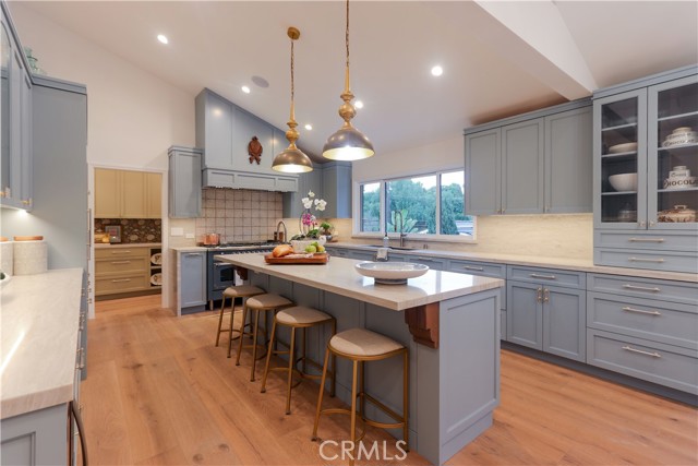 The breakfast bar center island is as functional as it is visually stunning! The bespoke cabinetry is thoughtfully designed with an exceptional array of integrated storage and organizational features throughout.