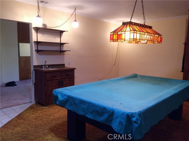 Game Room with wet bar opens up to covered patio.
