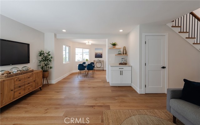 great room towards kitchen, dry bar on right