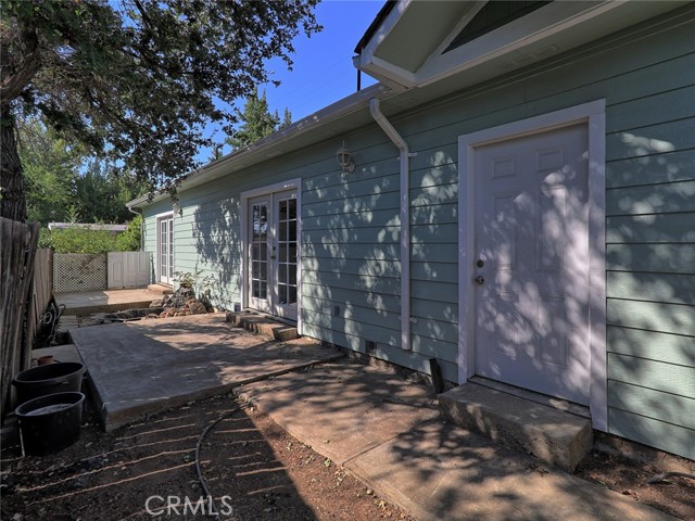 Side/Back patio pads w/ French door access from Master Bedroom, Kitchen and door to Garage. Water Feature between patio pads.  Exit to Street through Gate along walking path.