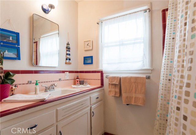 Original but nice bathroom tile. This is a full bath. Sunny west facing window.