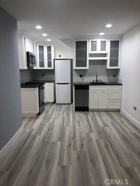 212 42nd Street Manhattan Beach, California This contemporary suite by the beach includes high-end finishes such as stainless steel appliances, quartz counter tops and a newly done kitchen. With a modernized bathroom and stylish river rock stand up shower (tub size), new floors throughout, new paint, AC/Heating, and the added bonus of having your own washer and dryer in the unit, this opportunity to live in luxury steps from the beach is not to be overlooked. Includes a garage space that fits two tandem vehicles.