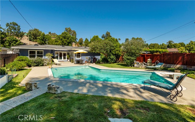 Another view of the backyard, concrete deck around pool