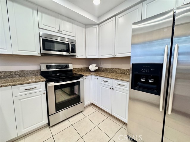 Sparkling stainless steel appliances add a sleek, modern touch to the updated kitchen.