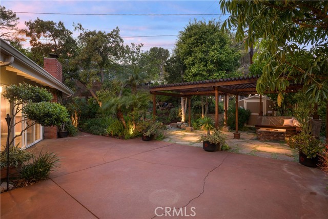 A spacious patio for outdoor dining, lounging, and relaxing with the waterfall and pond feature in the backdrop.