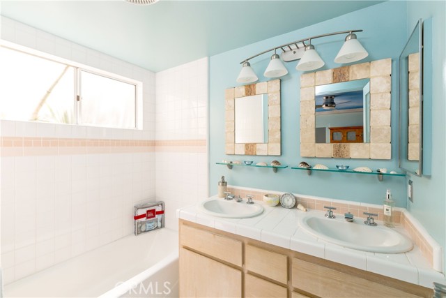 Soaking tub and shower in the second bath all decorated in the beach life colors!