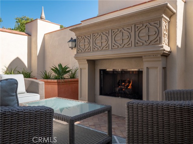 Cozy outdoor seating area and fireplace in the courtyard.