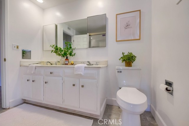 Main bathroom off hallway with dual vanity