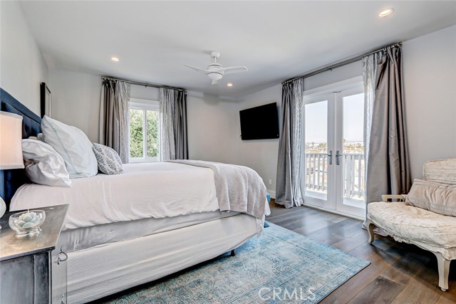 Downstairs primary suite with french doors leading to the Juliette balcony.