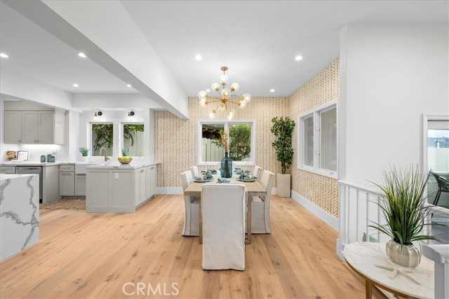 Decorator touches in dining area off of kitchen with stunning brass fixtures.