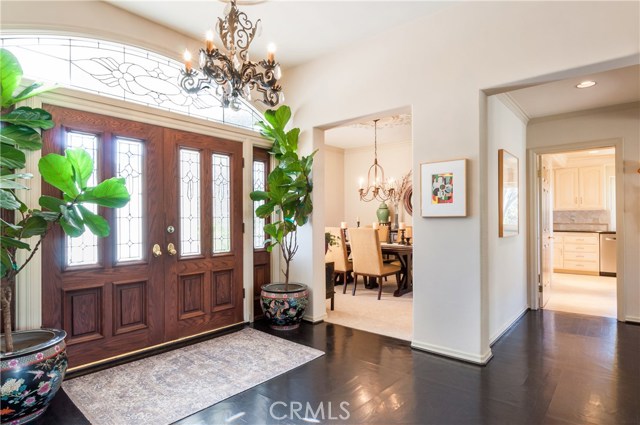 Formal entry with stained glass overhead and panels.