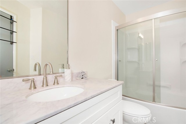 Remodeled bath with new bath tub shower combo and glass door
