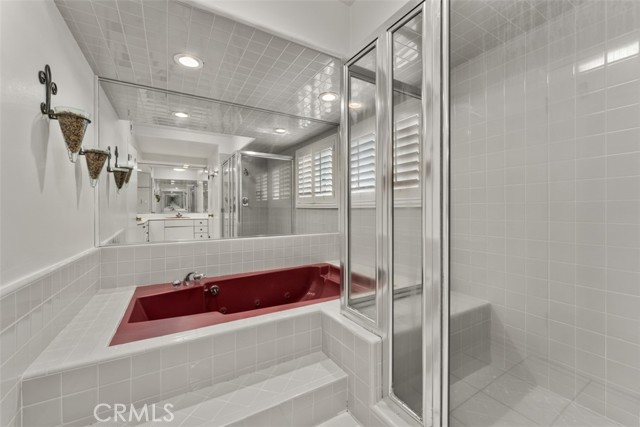 Unit 1 bathroom with shower and separate soaking tub.