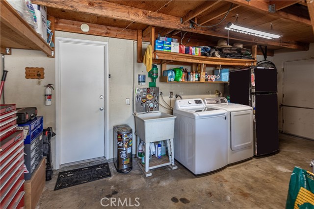 Entrance from garage; laundry area; door on right to side yard. The washer and dryer are included!