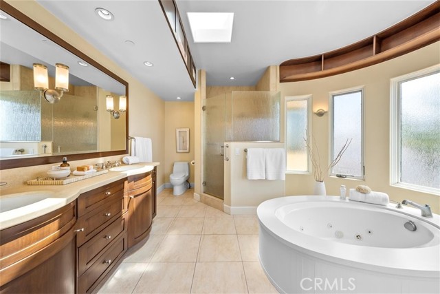 Primary bathroom with dual sinks, walk in shower, separate tub