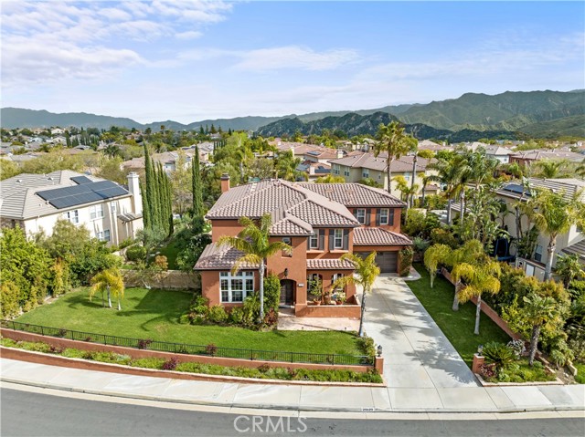 WELCOME HOME TO A BEAUTIFUL, ONE-OF-A KIND PROPERTY LOCATED IN THE HIGHLY DESIRABLE AND PRESTIGIOUS TORCELLO TRACT NEIGHBORHOOD OF STEVENSON RANCH! This spacious home boasts appx. 4,000 sq. ft., on over 12,200 lot size, 5 bedrooms and 5 baths (with 1 ensuite bed/bath downstairs) and additional guest bath and also features high ceilings, ample natural lighting throughout, an open floor plan, stone flooring, formal living room and a grand dining room w/French doors open to cozy patio ideal for indoor/outdoor dining. The inviting, gourmet kitchen has stainless steel appliances, granite countertops, center island and custom backsplash and is open to the great family room w/fireplace. Adjacent to kitchen is the bonus room (optional game room/man cave/cigar room) with a  state-of-the art wine cellar. A sweeping staircase leads to a spacious landing with built-ins. The fabulous primary suite offers a retreat area with a luxurious marble bathroom with double sinks, free-standing tub, huge shower area, and a large walk-in closet. The amazing, entertainer's park-like backyard offers a custom pool and spa, BBQ area, fire pit with seating area and a large grassy yard with olive and fruit trees, with close proximity to award-winning schools, parks, freeways, shops and restaurants all make this unique compound ideal and ready to be enjoyed by a new owner to call HOME!