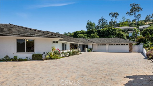 2 Bowie Road Rolling Hills, California Situated in the prestigious 24 hours guard gated city of Rolling Hills. This one level beautiful Rolling Hills home with specular ocean, city, and mountain view, has been extensively remodelled in 2014. Featuring 5 bedrooms, 7 bathrooms, plus office with beautiful walnut build in shelves, new electrical, plumbing, a/c & heating, new Anderson windows and doors, ... etc. The grand entrance with new pavers thru out the driveway, entrance, and backyard. 3 car garage with direct access into the home and additional parking spaces. Resort like entrance leads into the new classic living room with custom marble fire place, beautiful grand circular dining room, a large family room with curved fireplace and luxury onyx counter top bar, and a beautiful powder room with full bath and guest closet. The modern expensive country style kitchen features a large island, stainless steel appliances, wine storage, sub-zero refrigerator, and conventional pot filler. Floor thru ceiling glass windows, sliding doors thru out the house and hallway. From family room, hallway, pool bathroom, and master bedroom all lead to the large landscaped backyard with a rounded modern fireplace and beautiful, tranquil fountain, and a huge standard size pool. Huge master bedroom with luxury master bathroom with large steam room and double size spa bath tub. All bedrooms have their own attached bathroom. New beautiful walnut hardwood flooring and expensive amble adorns the home.