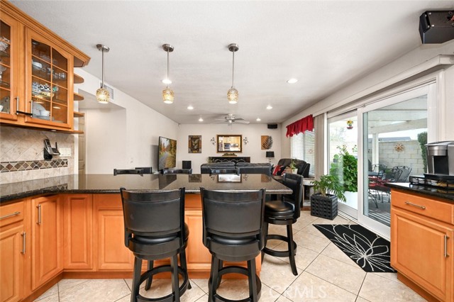 Stunning glass cabinetry adds a touch of sophistication while chic pendant light fixtures add to the décor.