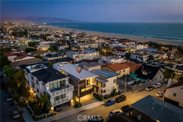 232 26th Street Hermosa Beach, California BIG OCEAN VIEWS from this Warm Beach Modern Home in one of North Hermosa Beach's most desired neighborhoods. Jon Starr Design and exquisitely built by Lombardi Construction with wonderful use of high end materials including Fleetwood windows, SubZero and Wolfe appliances and reclaimed barn wood etc. Ocean, White water, Hermosa Beach Pier and Malibu Views for days. 4 bedrooms, 4 1/2 bathrooms. Flex room on entry level that opens to back yard with gas fire pit. Wide open top floor with west facing views throughout and a built in ocean view breakfast nook. Located in the heart of a classic coastal neighborhood, this modern beach house is a nucleus for family and friends. This peaceful retreat unfolds to reveal a thoughtful balance between indoor and outdoor living with many unexpected features. Relaxed but refined, crisp but inviting,the casual elegance of this purposeful environment embraces an active beach life where sun, sand, ocean breezes, and memories are closely interwoven.