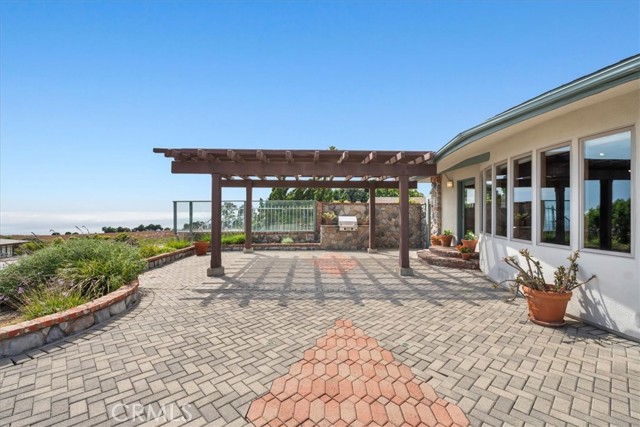 Outdoor patio with pergola, landscaping, pavers, BBQ, and views of the ocean and Catalina.