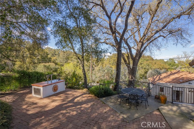 The top patio which is off the kitchen area has brick pavers and captivating views.