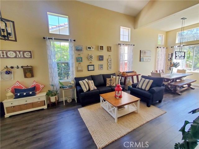 Living room with vaulted ceiling and main dining area.