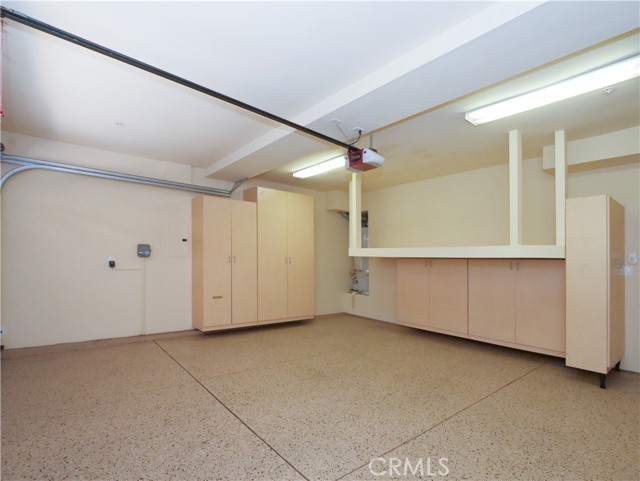 Garage with cabinets for storage.