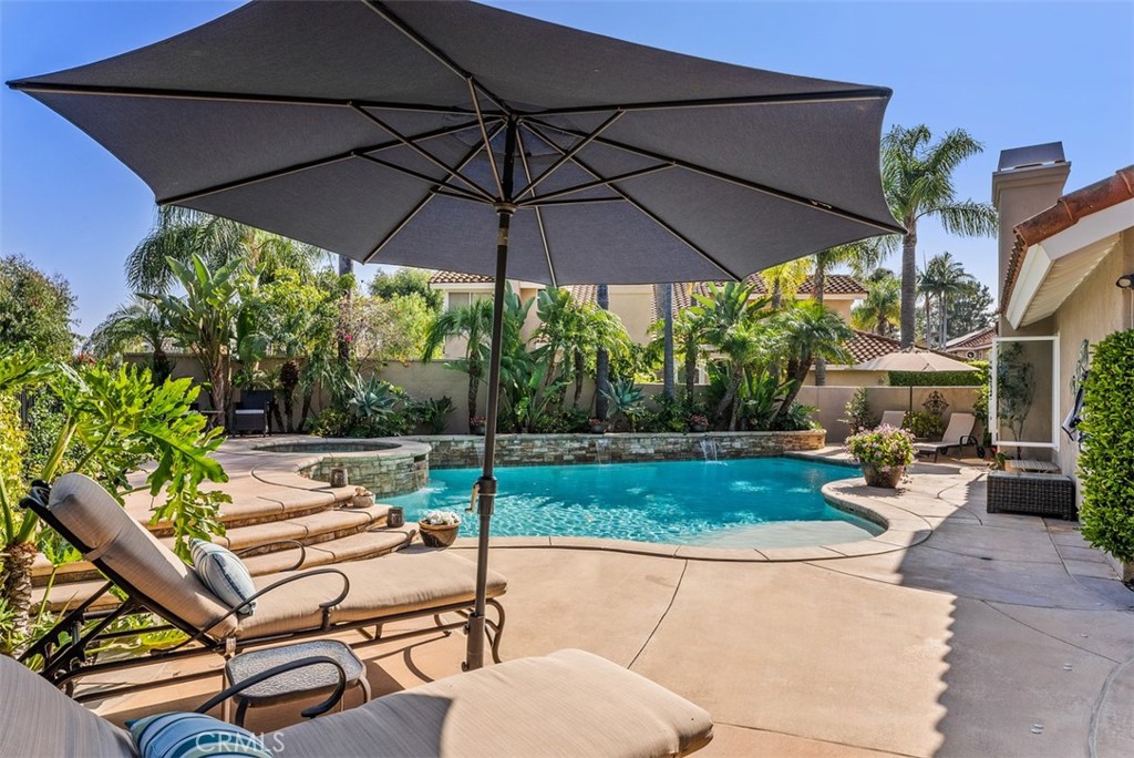 Welcome to this meticulously upgraded and beautifully maintained home in Rancho Niguel at the end of a cul de sac. Located in a highly sought-after neighborhood, this property offers a wealth of exceptional features and improvements, creating a true family haven with 5 bedrooms and one conveniently located on the main level. Brand-new Arizona wide plank tile floors and baseboards were installed throughout the main level, achieving a cohesive and modern look. The living room's flooring was thoughtfully raised to match the entryway and adjacent living spaces, providing a seamless flow and boasts a stunning limestone fireplace, while the family room features a captivating stone fireplace, both adding warmth and charm. An integrated entertainment center was custom-built to accommodate all your media needs.  The downstairs bathroom was refreshed with updated fixtures and finishes, and gorgeous grass cloth wallpaper. The downstairs bedroom (used as an office) cabinets were professionally painted to enhance the workspace. The kitchen received a comprehensive overhaul including an enlarged island, featuring custom cabinets, elegant quartz countertops, and top-of-the-line Dacor appliances, including an oven, microwave, gas range, and custom hood with wood detailing. The entire electrical system was updated, and in 2023, new appliances, including a dishwasher and refrigerator, were seamlessly integrated.Fresh paint was applied throughout the entire home.  New carpet installed on the stairsNew Milgard windows throughout the home. Both upstairs bathrooms have been remodeled, with the primary bath have beautiful millwork above the dual sink vanity. Primary closet thoughtfully remodeled to provide expanded storage & organization options.  Expansive outdoor area with large pool with a baja step, jacuzzi, bar, BBQ, LED nightscaping, fireplace and captivating hardscape and landscape enhancements, providing an ideal setting for relaxation and outdoor entertaining. Solar installed (leased) for energy efficient living.  Rancho Niguel offers excellent amenities inclusive of a lap pool, tennis courts, pickle ball courts, gym, sport courts, park, volleyball, and clubhouse that can be rented out for parties.