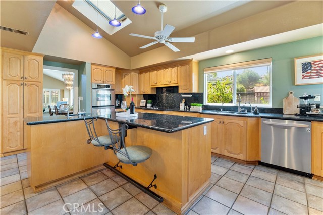 This kitchen is for those that like to entertain. So much space to enjoy and cabinets to store. Granite counters, built in chairs at island, double oven, stove cook top, double pane windows, skylight, second sink, tile flooring. Built in refrigerator, ceiling fan, microwave, dishwasher.