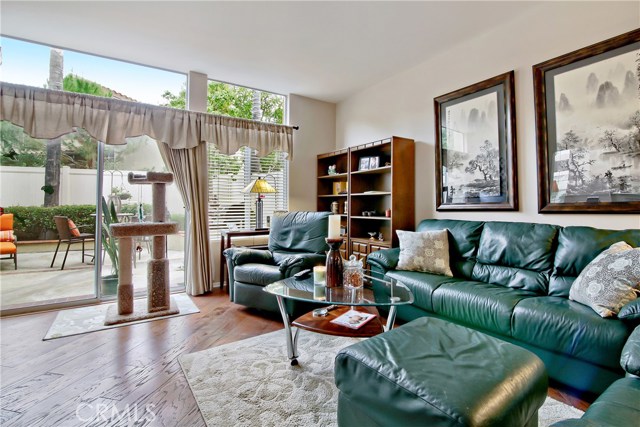 Bright family room w/ hardwood floors looking toward back patio