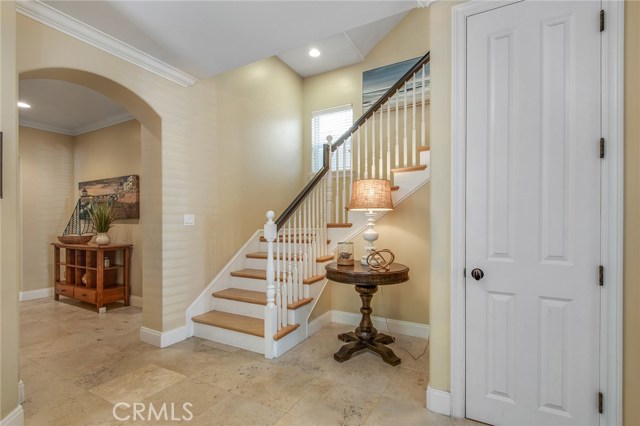 Entry with high ceiling.  One of two staircases between levels one and two.