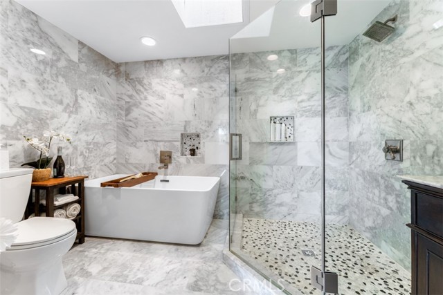 Primary bathroom with double sinks, walk in shower, and soaking tub