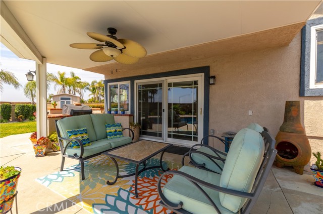 Patio cover with decorative fan and barbeque.