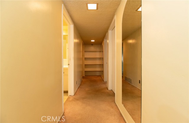 Hallway on lower level has laundry room, 2 bedrooms, 2 bathrooms and family room