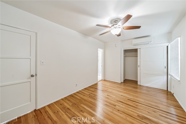 Master bedroom toward 3/4 bath, wardrobe closet and air conditioner