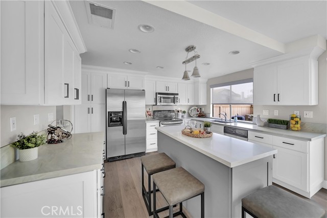 Completely Remodeled Kitchen Features Quartz Countertops, Center Island, Custom White Shaker Soft-Closing Cabinetry, Deep Pots & Pans Drawers, Pantry with Pull-Outs, Pendent Lights Above Center Island, Recessed Lighting, Stainless Appliances, Farm Sink