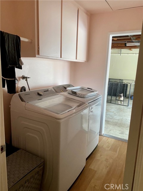 Walk-in laundry room w/cabinets and large enough for side by washer and dryer. Also, entry to 2 car garage.