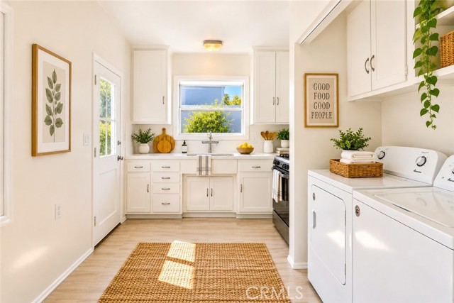 The Kitchen is Very Efficient with a Dining Area, Laundry and a Door Leading Out to the Rear Yard. Virtually Staged