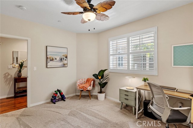 Bedroom 3 - used as an office, with wood shutters, ceiling fan, large closet.