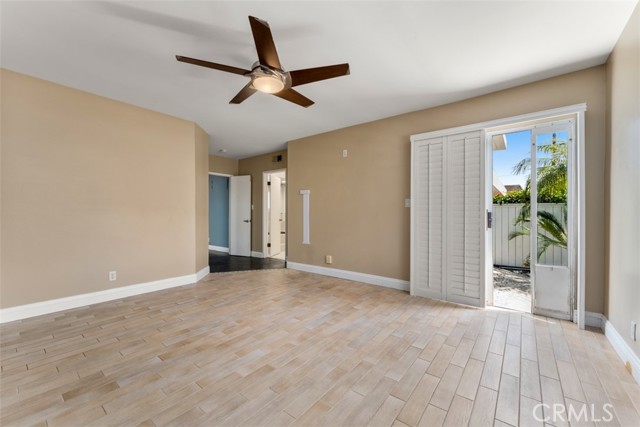 Unit 1 bedroom with sliding door to the backyard.