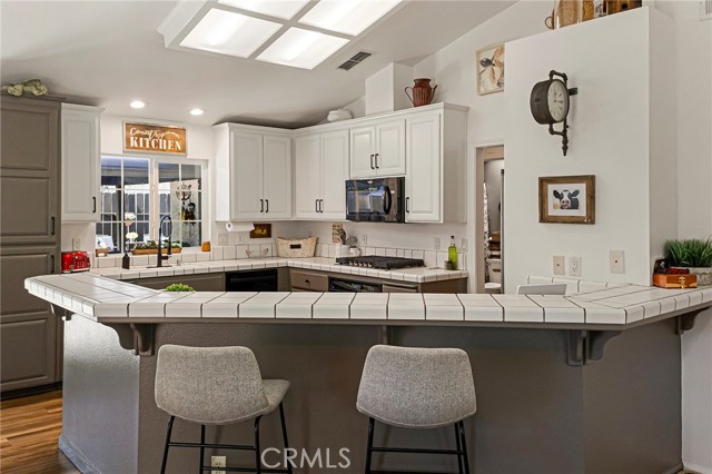 Roomy open kitchen with bar seating.