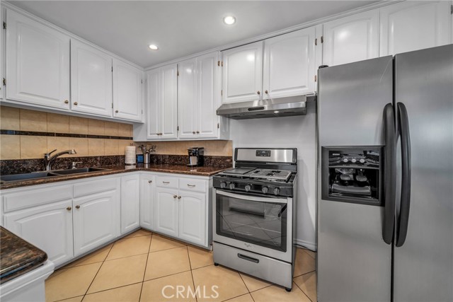 Upgraded kitchen with stainless appliance, plenty of counter space, and cabinets for days.