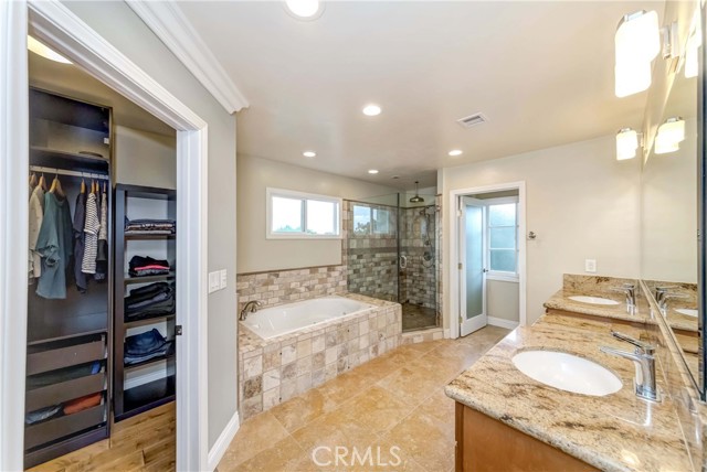 Master bathroom includes walking closet on left side, bathtub, shower, toilet room and double sinks