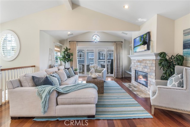 Bright and open living room with vaulted ceilings, hardwood floors, fireplace.  Makes for an inviting place to end the day