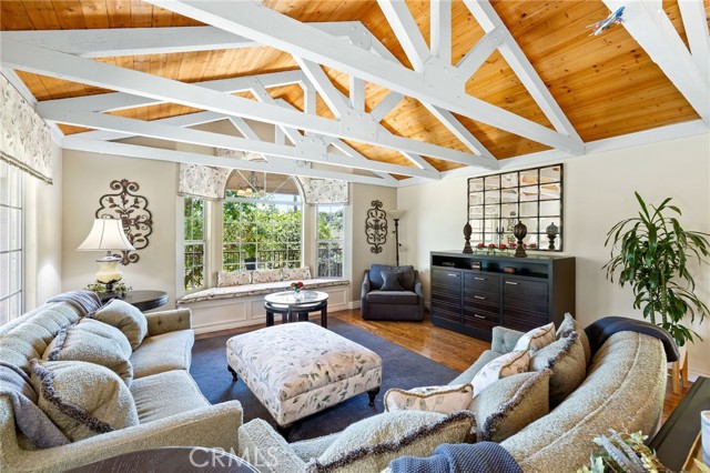 Family room with hardwood flooring, tongue and groove ceiling, and exposed beam ceilings.